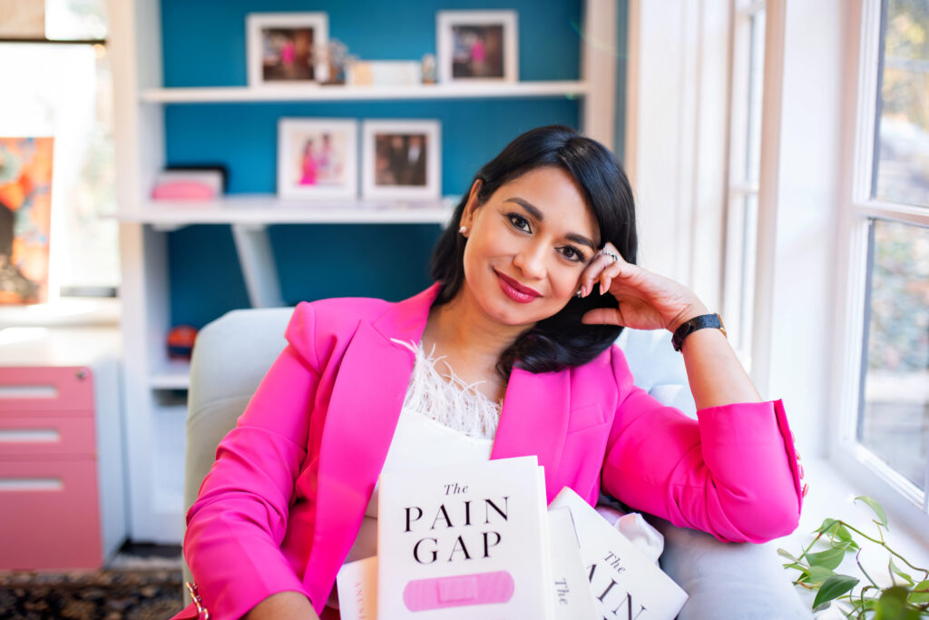 Anushay holding her first book, The Pain Gap